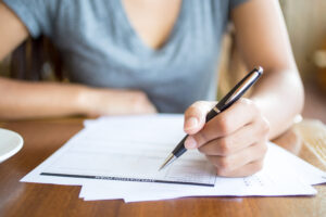 Close up of woman filling application form